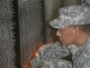 soldier-searches-names-memorial-wall soldier-searches-names-memorial-wall